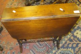 A late Victorian walnut drop-leaf Sutherland table on turned and ringed supports