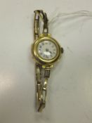 A ladies 9 carat gold wristwatch, the white enamel dial set with Arabic numerals
