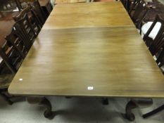 A late 19th/early 20th century mahogany wind out dining table on cabriole legs, with later