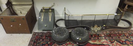 A Victorian brass and wirework spark guard, a Victorian serpentine steel and bronze fender, a pair