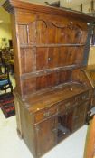 A 19th Century pine dresser, the two tier boarded plate rack over three drawers, central dog