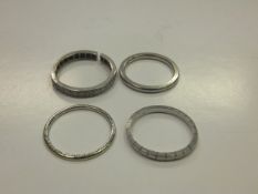 A white band stamped "Platinum", together with two others similar and a white gold and diamond set