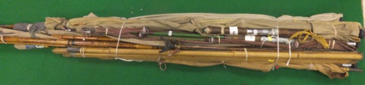 A large collection of vintage fishing rods including whole cane, split cane and fibreglass examples