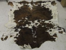A large brown and white cow hide