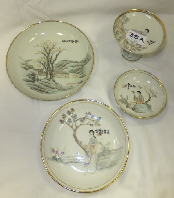 A Chinese porcelain trio, each piece painted with a lady in traditional dress, beside a blossoming