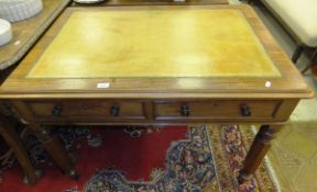 A Victorian mahogany writing table, the top with tooled and gilded leather writing surface, with