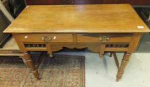 An Edwardian stained pine dressing table / writing desk with turned spindle decoration, raised on