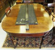 A Regency mahogany D-end dining table, the plain top with two extra leaves and reeded edge raised on