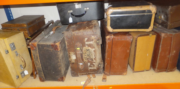 A collection of leather bound and canvas trunks together with a Harrods velum covered case, two