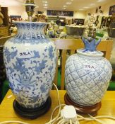 A Chinese blue and white table lamp raised on circular wooden plinth, together with a further blue