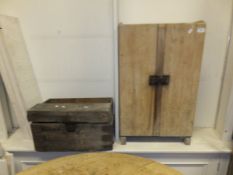 A pine two door cupboard, pine trunk, and another trunk