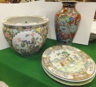 A Chinese porcelain vase, polychrome decorated with a pheasant amongst blossoms on an iron red