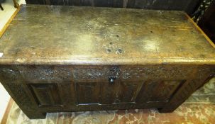 A 17th Century Continental oak coffer, the top with later cleated ends and moulded front edge over