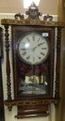 A drop dial wall clock with decorative parquetry banding and inlay throughout, Roman numerals to the