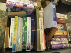 Two boxes of assorted jigsaw puzzles and children's games to include boxed wooden chess pieces