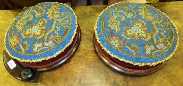 A pair of 19th century rosewood framed circular footstools with 19th century beadwork tops