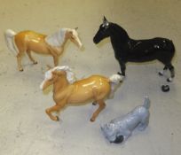 A box containing a Beswick model of "Champion Black Magic", two Beswick Palomino horses, a Royal