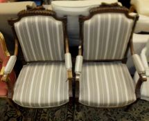 A pair of French salon elbow chairs with carved acanthus decoration and turned and fluted legs,