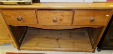 A 19th Century pine dresser, the plain top above three drawers and a recess