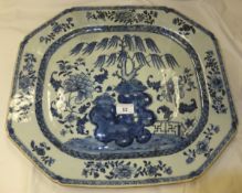 A 19th Century Chinese porcelain meat plate painted in underglaze blue with rock, willow, flowers