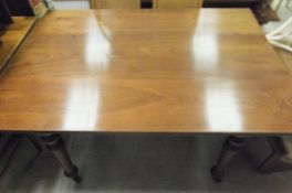 A rectangular mahogany dining table on turned legs