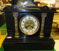 A late Victorian black marble cased mantel clock of architectural design, the French eight day