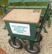 A small four wheel trolley bearing plaque inscribed "Keith Harding's World of Mechanical Music"