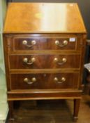 A 20th Century mahogany veneered bureau of small proportions with fan inlaid medallion and chevron