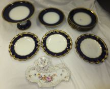 A set of three Royal Crown Derby cabinet plates with cobalt blue, gilt and jewel decorated wavy