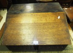 An 18th century oak table top bible box, the plain top flanked by carved sides opening to reveal a