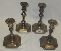 A pair of silver plated candlesticks stamped "EPC Harrods", together with a larger pair stamped "