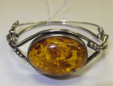 A silver mounted amber bangle