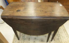 A 19th century mahogany oval drop leaf Pembroke table with single drawer, on square tapered legs