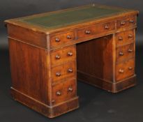 A late 19th/early 20th century mahogany pedestal desk, the rectangular top with tooled and gilded