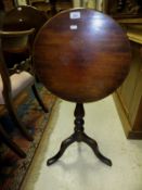 A Victorian mahogany occasional table, the circular snap top on turned and ringed pedestal to