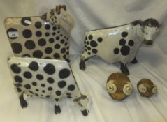 WITHDRAWN Three studio pottery figures of spotted cows of stylised "square" form, together with