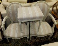 A pair of cream painted French salon elbow chairs, upholstered in cream and taupe striped fabric,