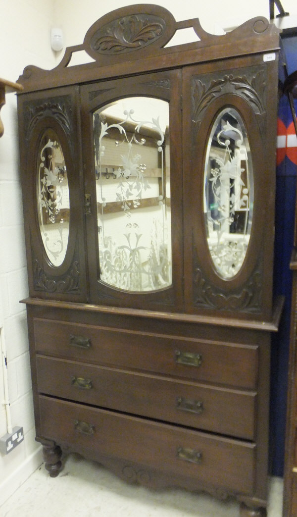 A Victorian linen press, the upper section with mirrored door and panels over three long drawers