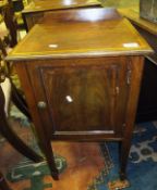 An Edwardian mahogany and inlaid pot cupboard, the single panelled door on square tapering legs to