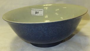 A Chinese porcelain bowl of slightly flared form decorated in cobalt blue and with incised