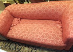 A drop arm three seater chesterfield sofa upholstered in pale red damask style fabric