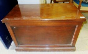 A mahogany chest with rising lid and brass handles