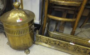 A circa 1900 brass coal bin of cylindrical form, the domed cover to pierced sides with ram's head