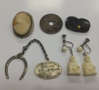 A box containing a pair of carved ivory Buddha earrings, a cameo brooch, an Oriental brooch, etc.