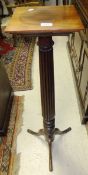 An Edwardian mahogany plant stand on reeded column support to tripod base (bed post conversion)