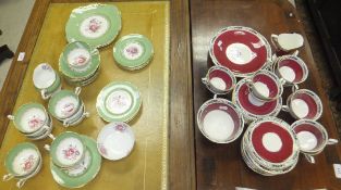 A collection of Royal Worcester tea wares with burgundy banding and green, blue and red foliate