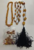 An early 20th century amber bead necklace, and another similar, together with various loose
