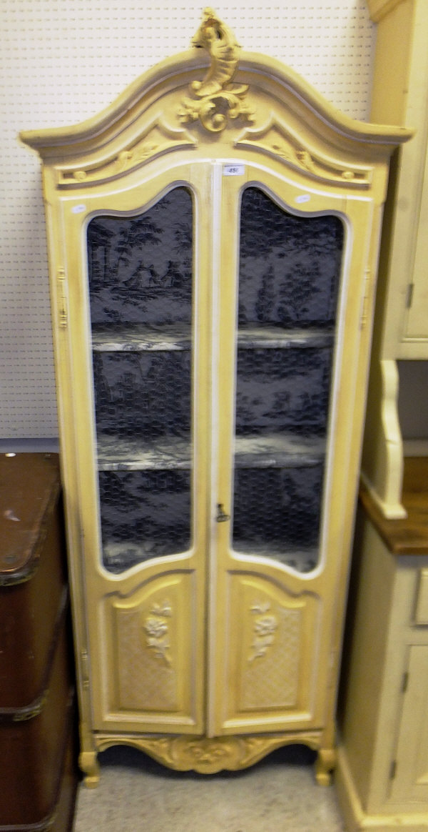 A modern painted two door cupboard with wirework panelled doors in the Louis XV taste