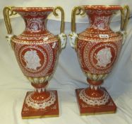 A pair of large porcelain urns with goat mask handles in the Greco-Roman style, decorated in white