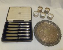 Five various silver napkin rings, together with a cased set of six silver handled butter knives